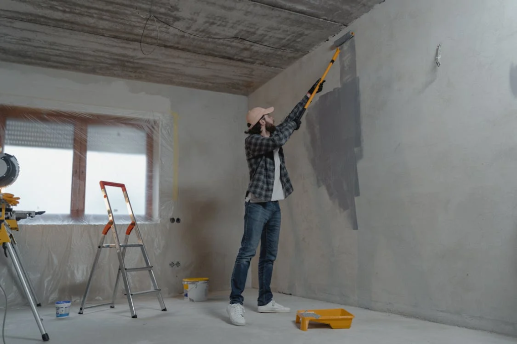 man painting a wall