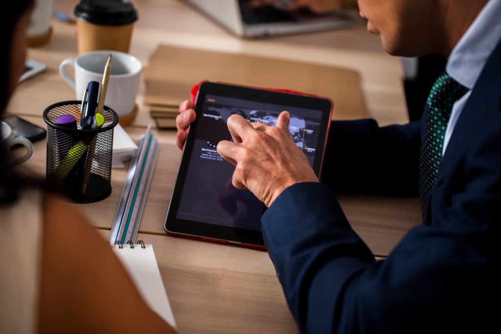 man using a software on a tablet